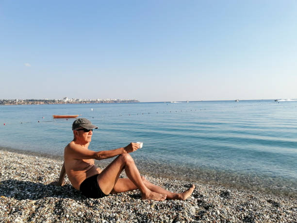 istock Senior adult sunbathing on the beach 1295847402