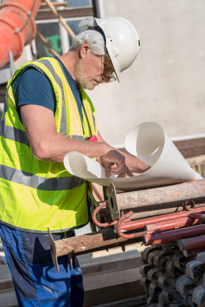 istock Mature men working on construction site at home 1295847629