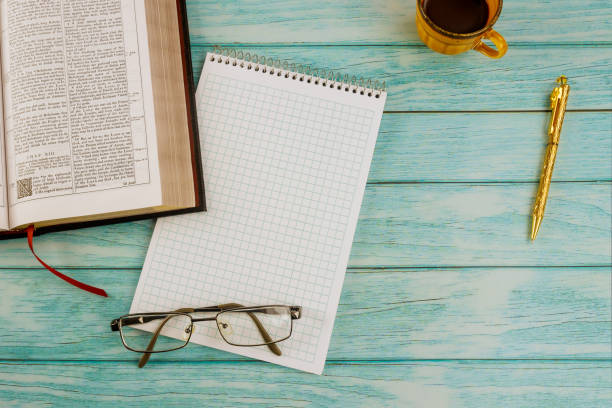 istock Cup of coffee while reading on Christian Holy Bible 1295848611