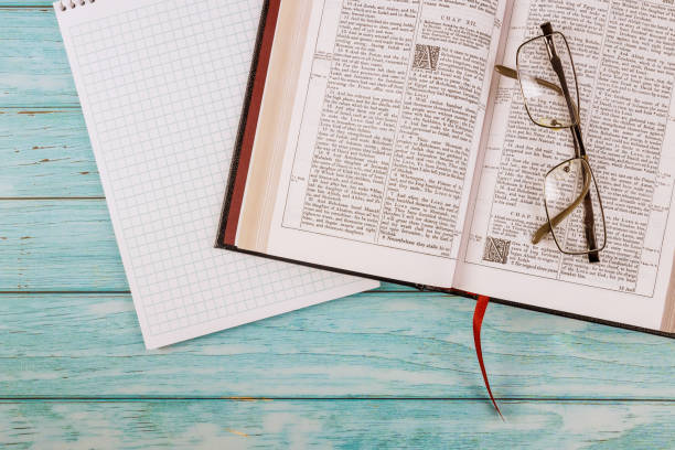 istock Opened the Holy Bible close up prayer time on notepad 1295848628