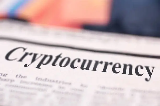Cryptocurrency written newspaper close up shot to the text.