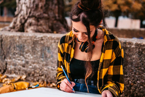istock Young woman drawing on artists canvas 1295850300