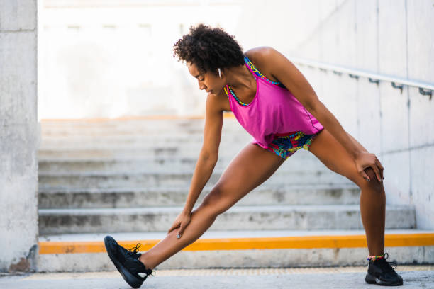 istock Afro athlete woman stretching legs before exercise. 1295851228