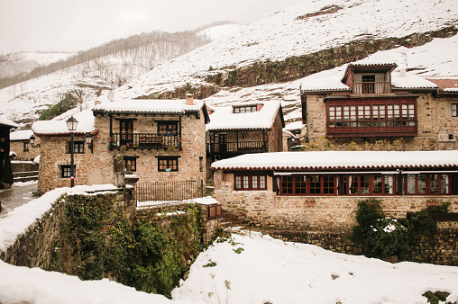 Barcena Mayor, a very touristic medieval village with typical architecture in Cantabria, Spain. Winter scene with snow