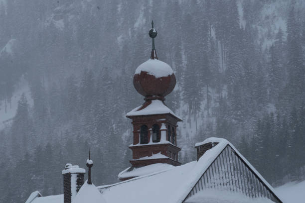 istock rooftop covered in snow in winter 1295853417