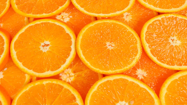 istock Slices of oranges as a background, top view. 1295854332