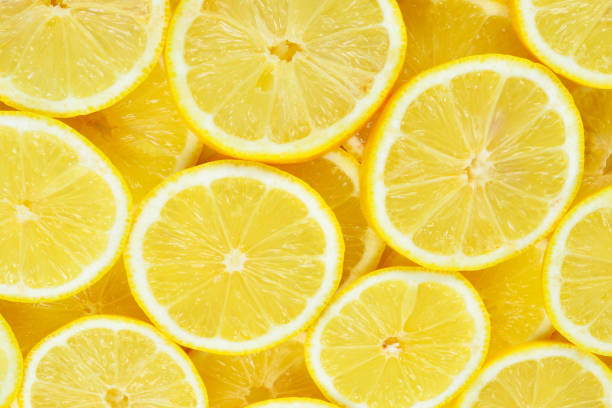 istock A slices of fresh juicy yellow lemons.  Texture background, pattern. 1295854356