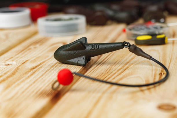 istock Lead sinker on wooden background macro shot 1295854377