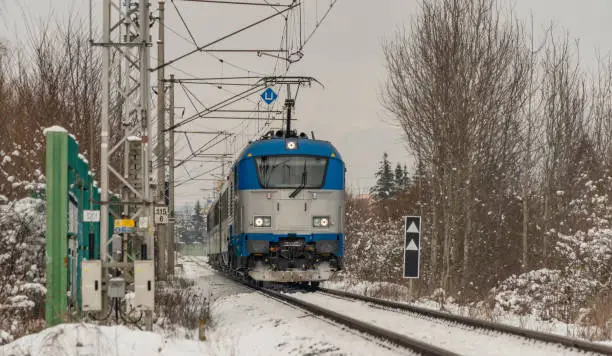 Fast train from Austria to Czech republic near Ceske Budejovice city in snowy cold day