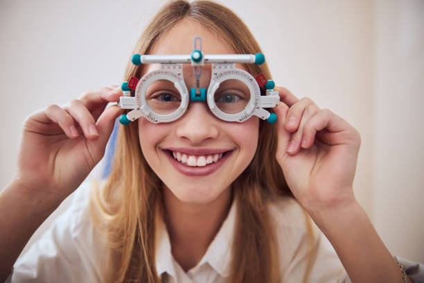 istock Beautiful cute lady holding special tool in hand isolated on white background in optometrist cabinet 1295856852