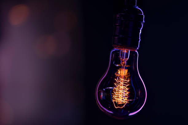 istock Silhouette of a burning lamp in the dark copy space. 1295857280