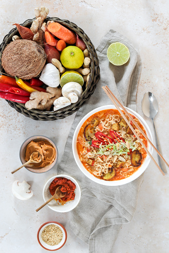 Asian Mie Noodle Soup with Tofu, Peanut, Lime and Chili as Flat Lay