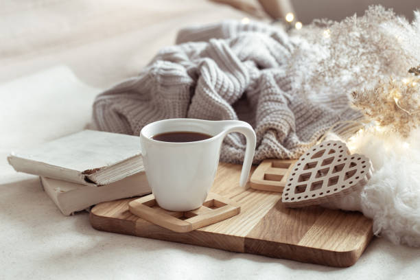 istock White cup with drink on blurred background home decor. 1295857946