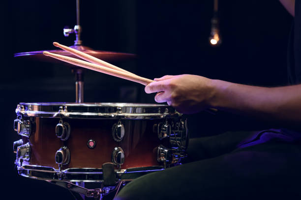 istock Drummer playing snare drum with sticks close up. 1295858274