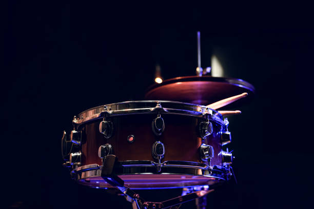 istock Snare drum and drumsticks close up in dark. 1295858295