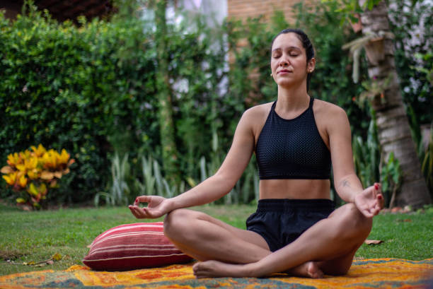 istock Young woman practicing yoga outdoors 1295858529