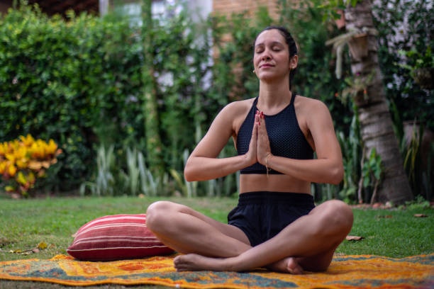 istock Young woman practicing yoga outdoors 1295858532