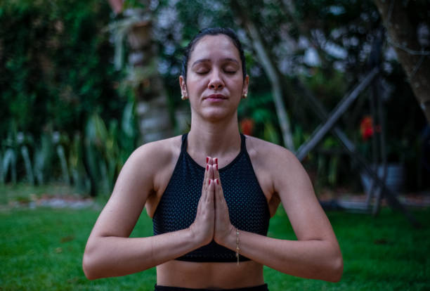 istock Young woman practicing yoga outdoors 1295858534