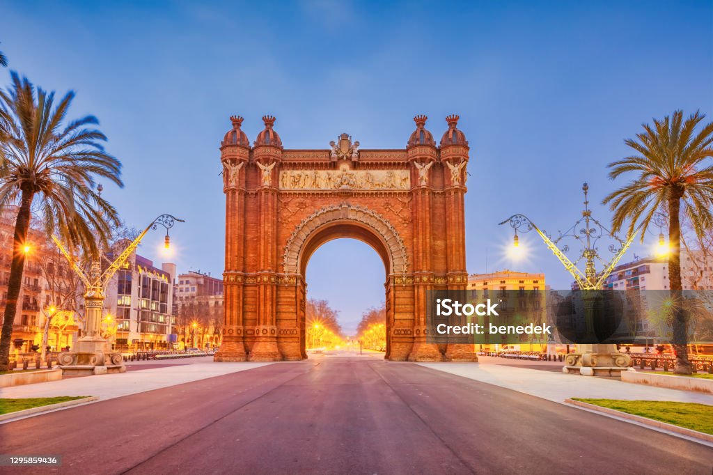 Arc de Triomf in downtown Barcelona Spain triumphal arch The Arc de Triomf, triumphal arch, in Parc de la Ciutadella, downtown Barcelona, Catalonia, Spain at dawn. The 19th century Arc de Triomf was built with colorful brickwork in Mudejar style. Barcelona - Spain Stock Photo