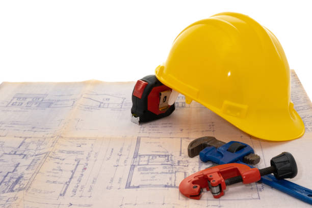 istock Blueprint housebuilding plans and construction equipment 1295859565