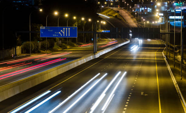 istock Freeway at night with car light trails 1295860398