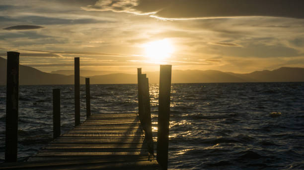istock dock in a lake at sunset 1295860600