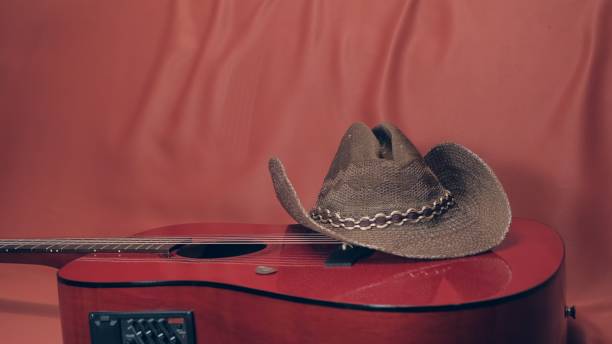istock Red acoustic guitar with a cowboy hat on it 1295860604