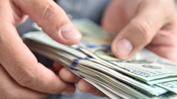 istock Usd dollar banknotes in hands businessman. 1295860726