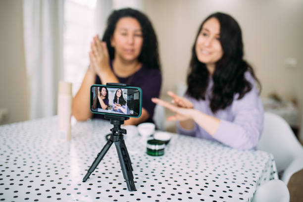 istock Female influencers using hand cream and explaining the product while vlogging 1295860858