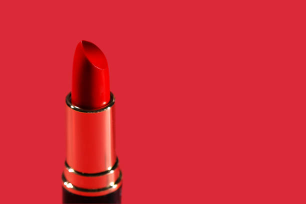 istock Red lipstick on the red background close up banner 1295861475