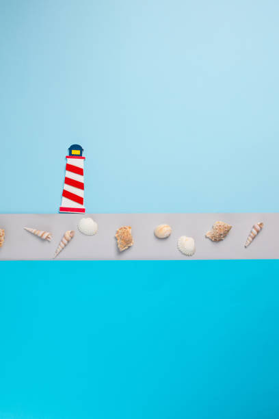 istock Creative concept of lighthouse and seashells background 1295861929