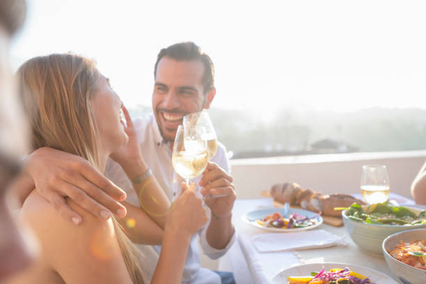 istock Couple on a date at as restaurant. They are drinking white wine and having fun. 1295862709