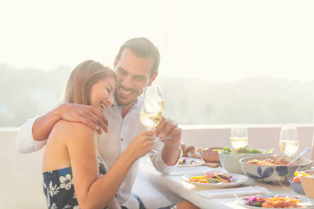 istock Couple on a date at as restaurant. They are drinking white wine and having fun. 1295862712