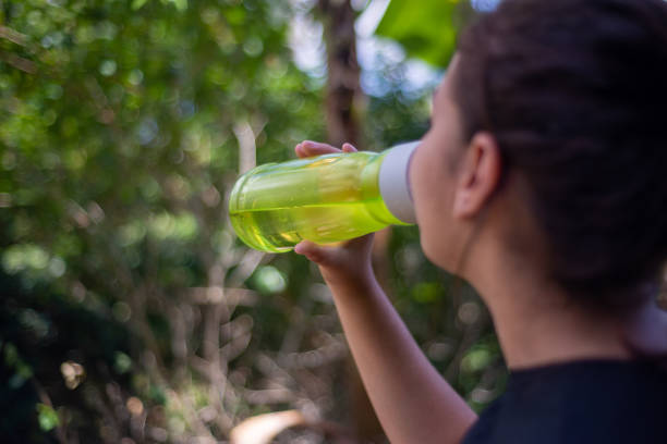 Young woman drinking water outdoors