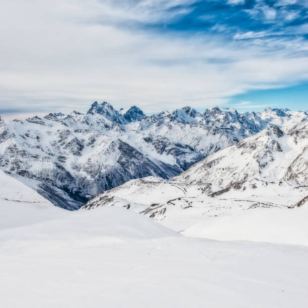 istock Snowy blue mountains in clouds 1295864990