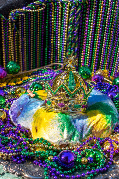 istock Mardi Gras King Cake topped with crown 1295865156
