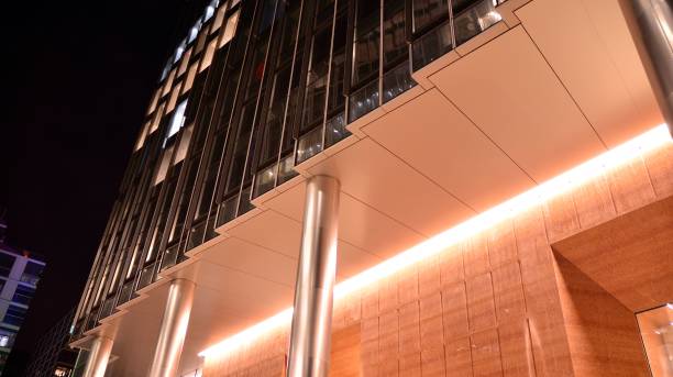 istock Pattern of office buildings windows illuminated at night. 1295865593