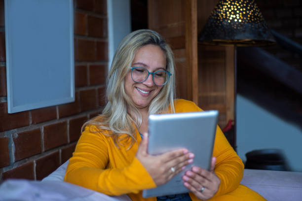 istock Woman doing online shopping at home 1295865689