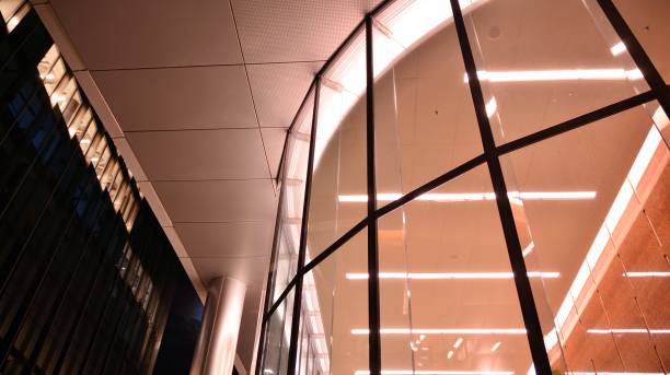 istock Pattern of office buildings windows illuminated at night. 1295865699