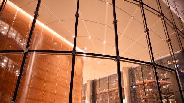 istock Pattern of office buildings windows illuminated at night. 1295866240