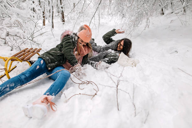 istock Two beauty girls in snow 1295866492