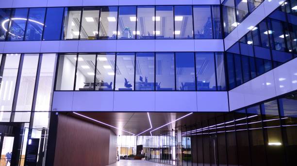 istock Pattern of office buildings windows illuminated at night. 1295866833