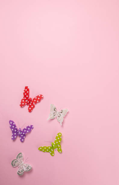 istock Colorful butterflies isolated on pink background 1295869007