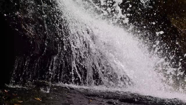 Waterfall pouring,splashing of mountain water,beautiful stream of water,drops and splashes,video wallpaper.