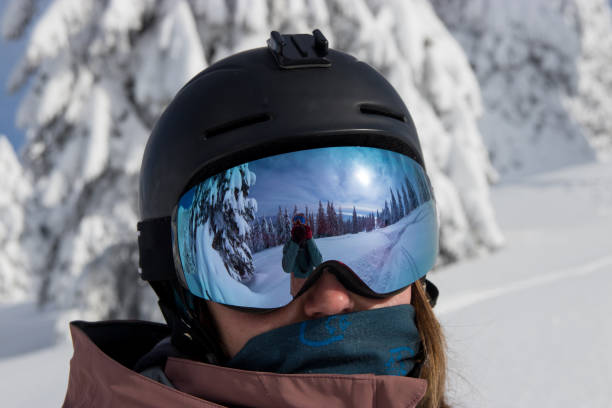 istock Woman skier portrait with reflection in goggles 1295870323