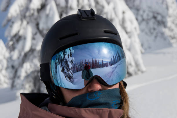 Woman skier portrait with reflection in goggles stock photo