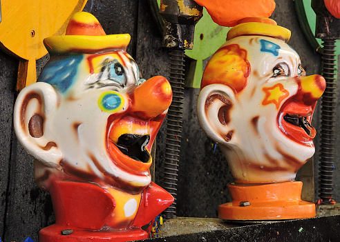 Two clowns in a carnival game at the fair.