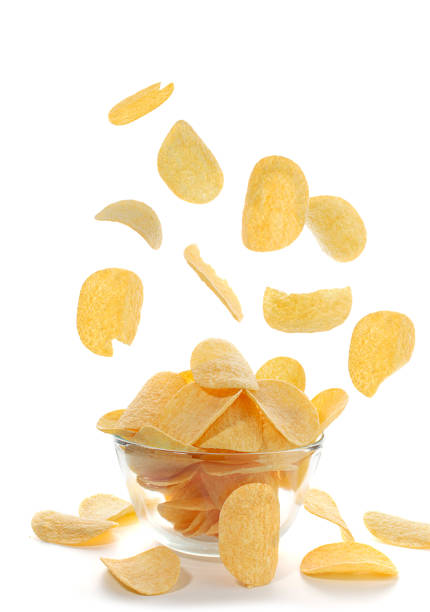 istock a lot of falling chips into a deep glass dish. White background. 1295873003
