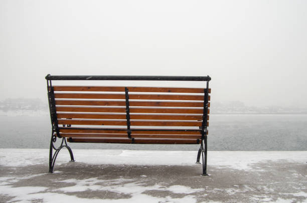 istock Bench on an empty city embankment, copy space for text 1295877102