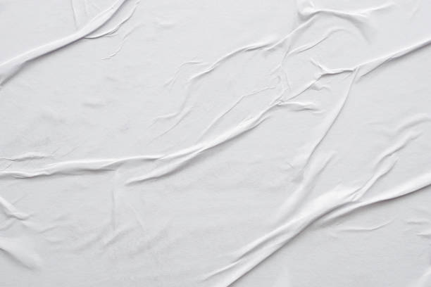 istock Blank white crumpled and creased paper poster texture background 1295877152